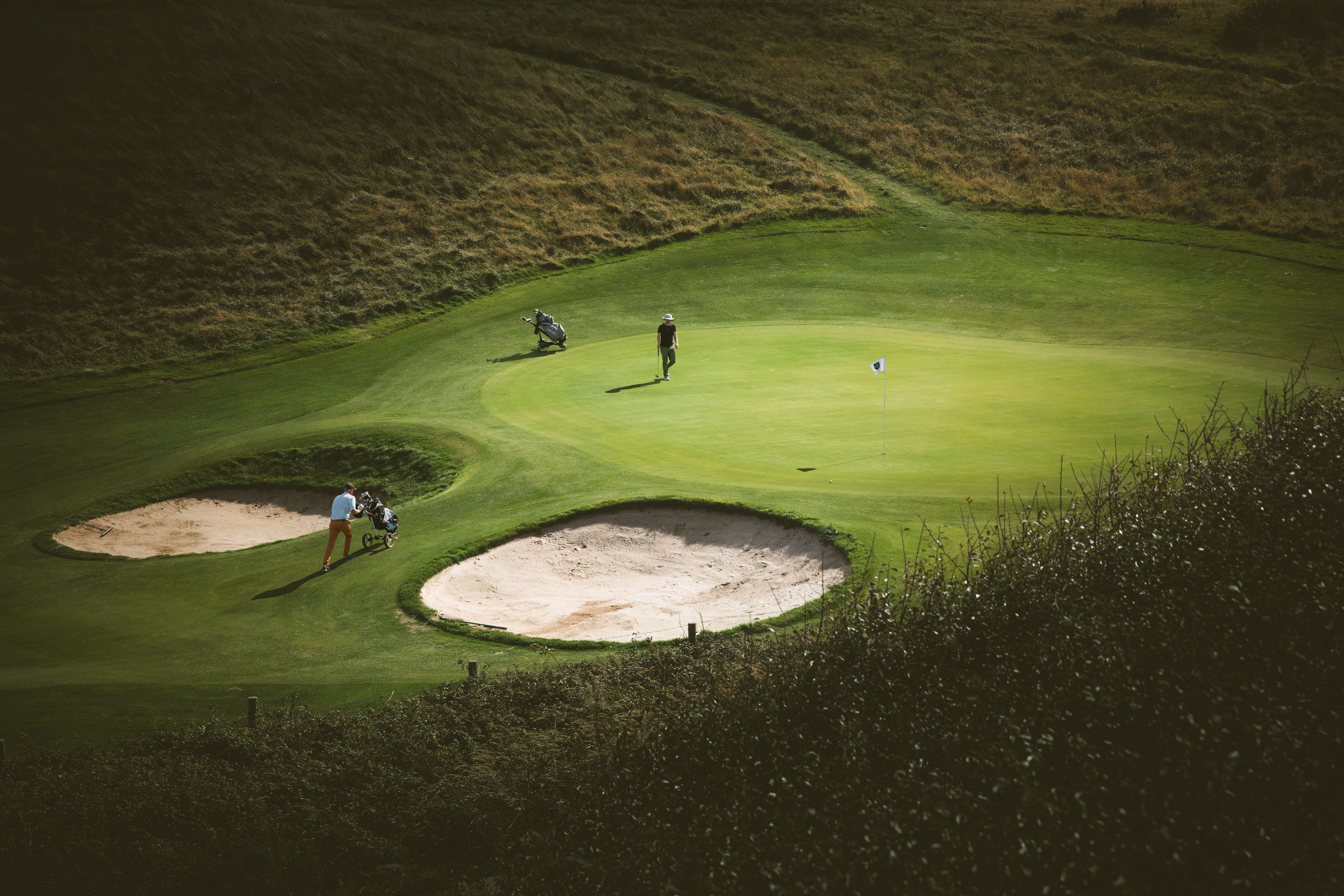 A driver at address behind the ball on the range
